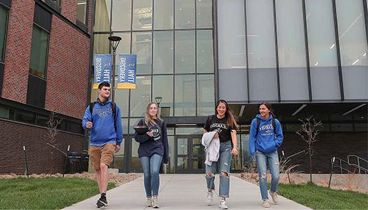 students walk outside discovery hall